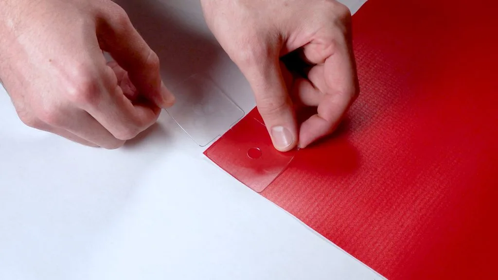 Step 1 — Stick the tab onto the banner corner