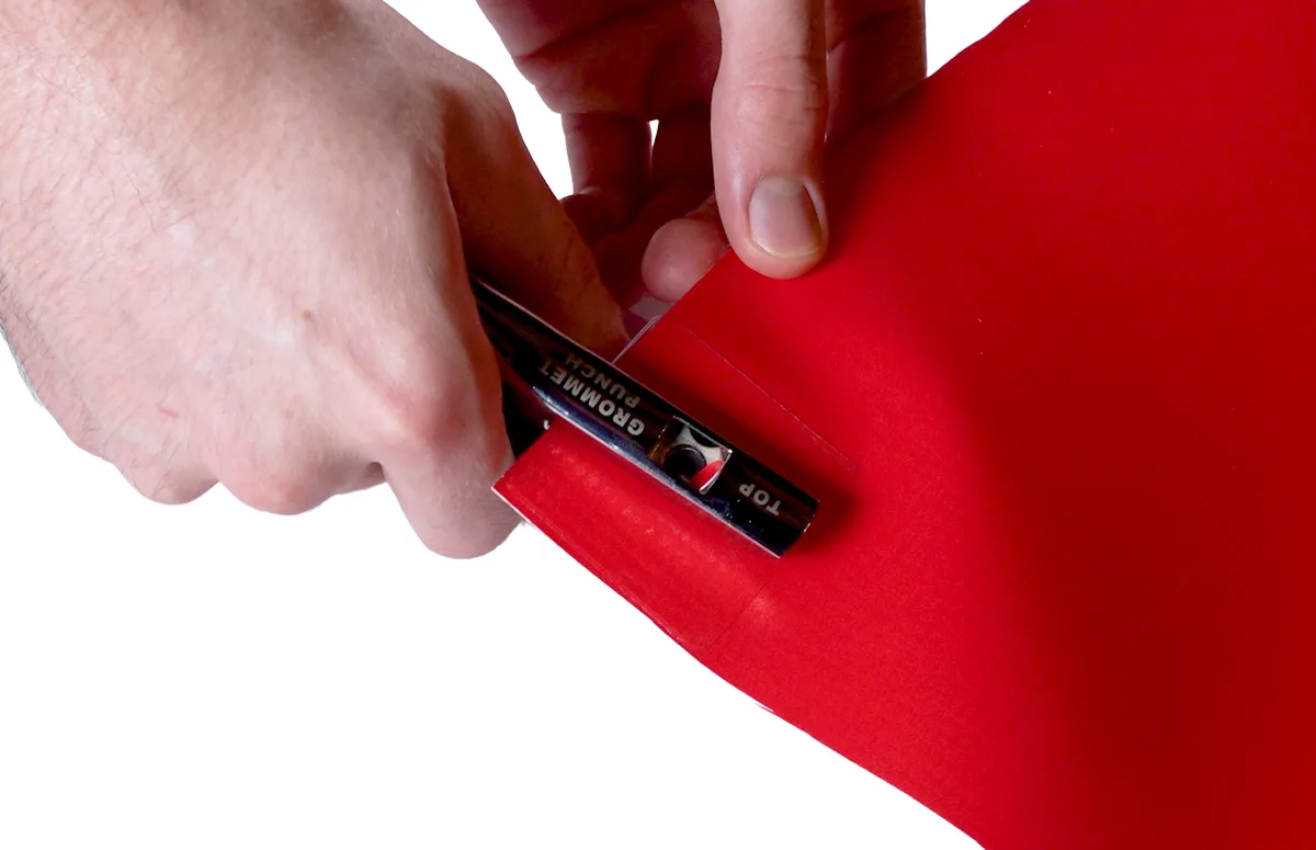 EZ Punch creating a hanging hole through a BravoTab on a banner
